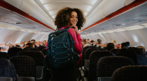 Woman on plane holding backpack